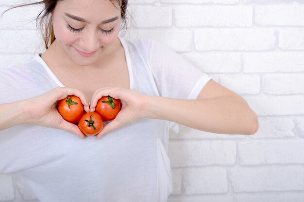 Smiling young woman with healthy fruit.