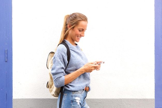 Smiling young woman with mobile phone