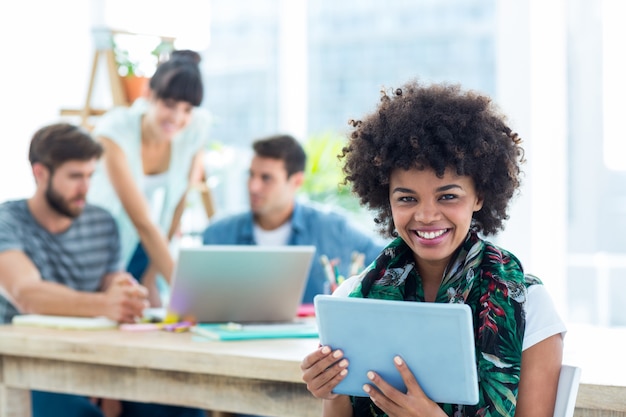 smiling young women using digital tablet