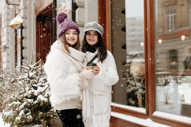 Smiling young women wearing warm winter clothing chatting