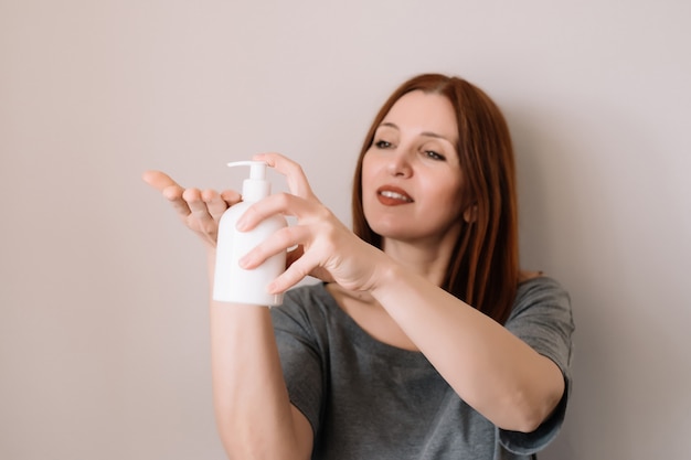 Smilling woman cleaning her hands.