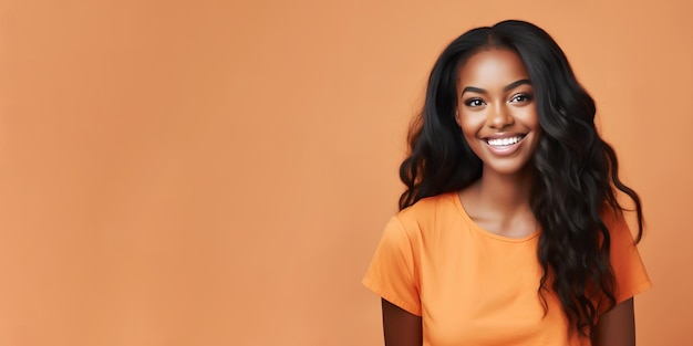 Smimilg young woman with dark skin and long groomed hair isolated on flat orange pastel background with copy space Model for banner of cosmetic products beauty salon and dentistry