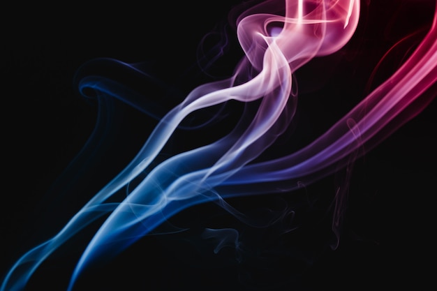 Smoke colorful floating in the air on dark background