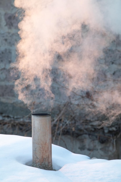 Smoke comes from the tube at winter