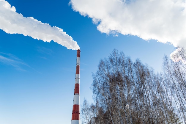 Smoke coming from the pipes of heat and energy plants over winter city Air pollution