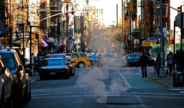 Photo smoke coming out from sewage amidst street