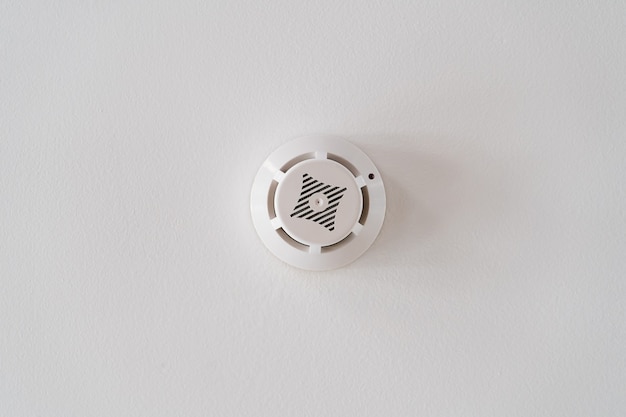 Smoke detector on the white ceiling. fire alarm. home protection in an emergency.