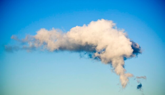 Smoke emitting from chimney against sky