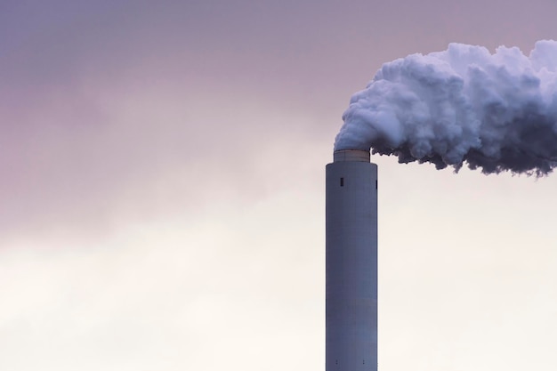 Photo smoke emitting from chimney against sky