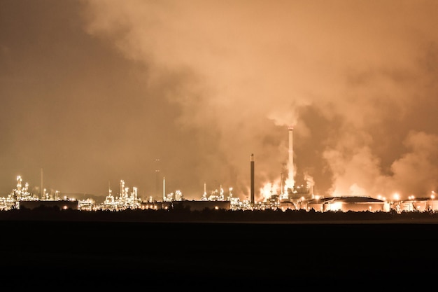 Smoke emitting from factory against sky at night