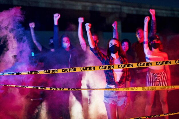 Smoke fists police Group of protesting young people that standing together Activist for human rights or against government