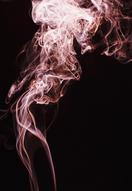 Smoke floating in the air on dark background