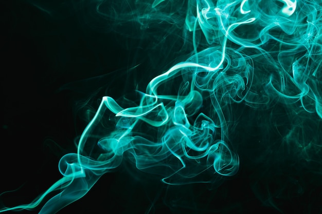 Photo smoke floating in the air on dark background