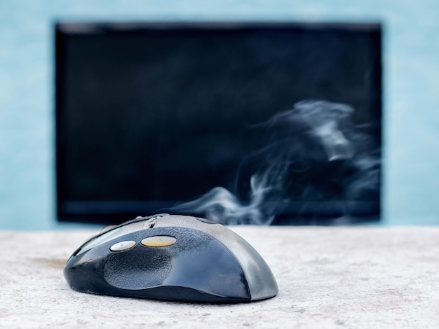 Smoke is coming from the computer mouse near the computer due to a malfunction