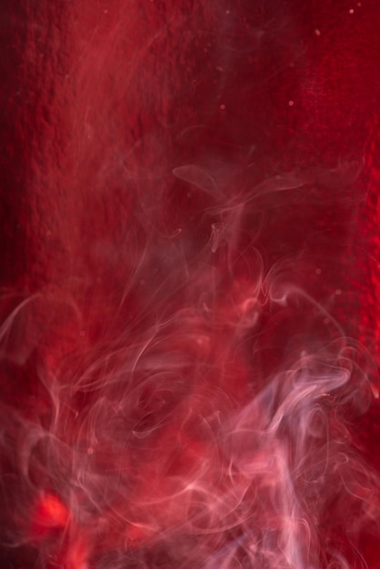 Smoke, smoke rising and creating beautiful shapes and a red background, Selective focus.