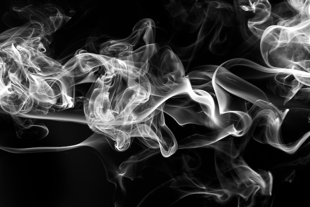 Smoke the white incense on a black background. fire 