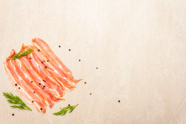 Photo smoked bacon slices with dried chili pepper, herbs and spices