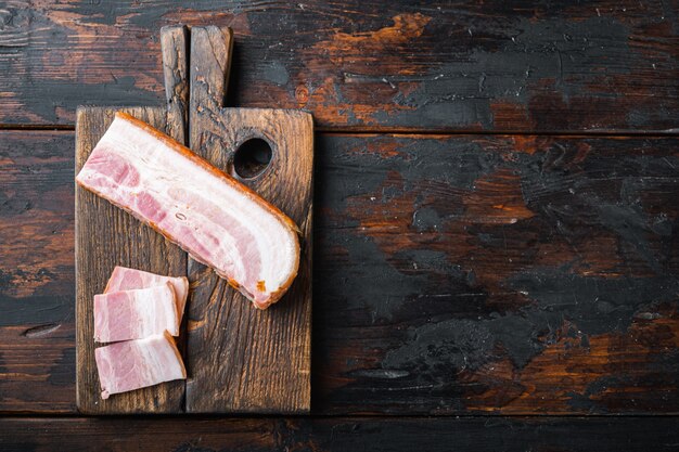 Smoked bacon with spices on a wooden board