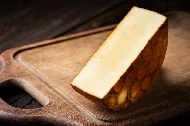 Smoked cheese Piece of smoked cheese on the table