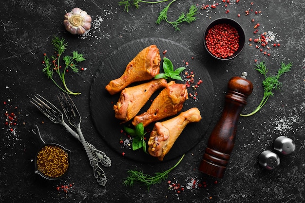 Photo smoked chicken drumsticks with spices and herbs top view free space for text