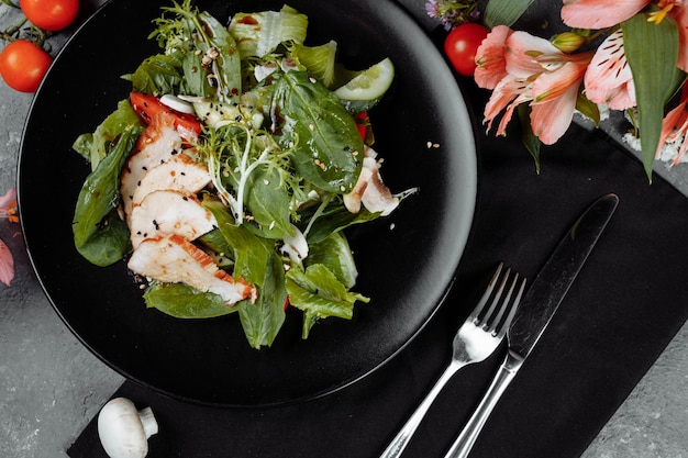 Smoked chicken salad on a black plate