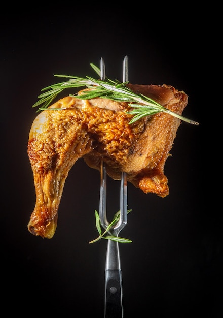 Smoked chicken thigh with rosemary on a fork Menu recipe for restaurant or hotel
