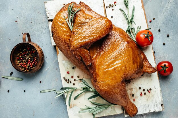 Smoked chicken with rosemary on a chopping Board