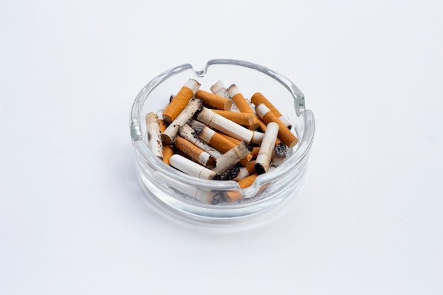 Smoked cigarettes on white background. Copy space