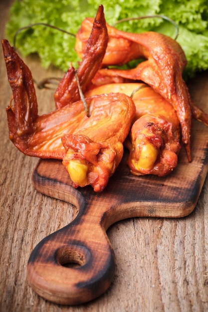 Smoked delicious chicken wings on the hardboard