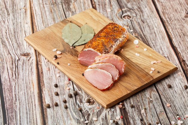 Smoked dried ham on a chopping board.