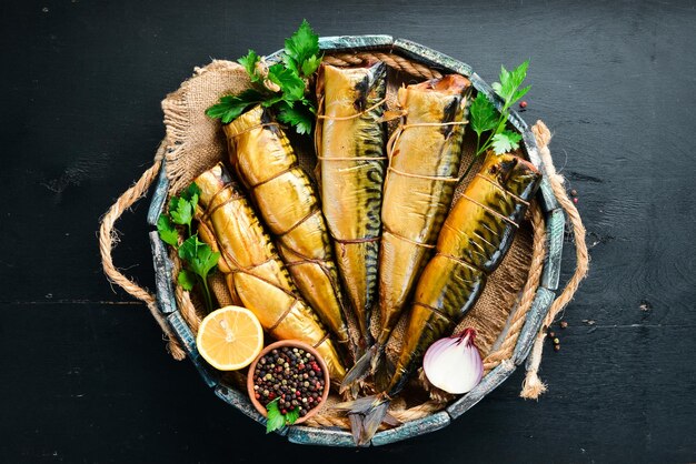 Smoked fish mackerel in a wooden box Top view Free space for your text