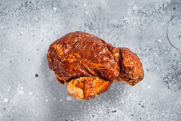 Smoked gammon - pork shoulder meat. Gray background. Top view.