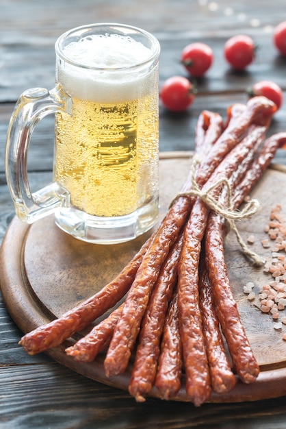 Smoked kabanosy sausages with mug of beer