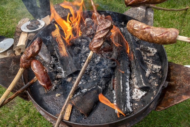 Smoked lard (Slanina), sausages and bread cooked on fire. 