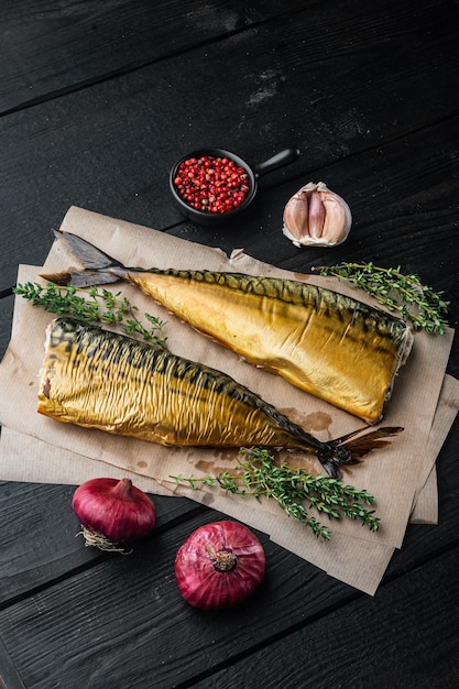 Smoked mackerel fish, on black wooden table