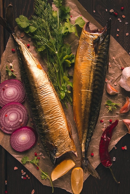 Smoked mackerel top view with spices on a wooden table no people selective focus