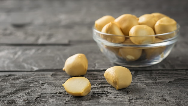 Smoked mozzarella cheese in a glass bowl on a wooden table