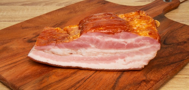 Smoked pork bacon on a wooden cutting board