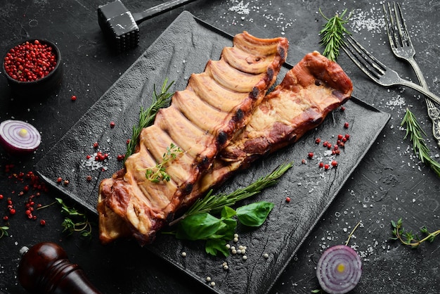 Smoked pork ribs with spices and herbs Top view Free space for text