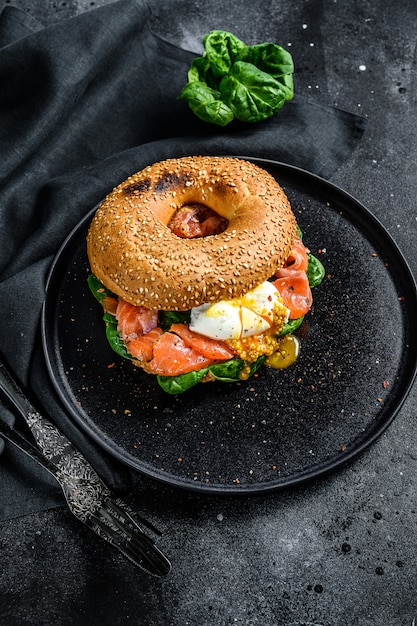 Smoked salmon bagel toasts with soft cheese, spinach and egg.