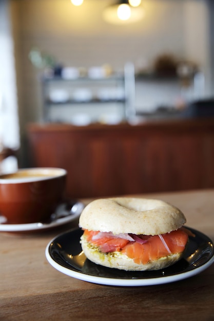 Smoked salmon bagel on wood background