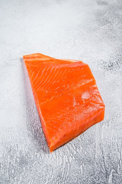 Smoked salmon fillet on a wooden table. White background. Top view.