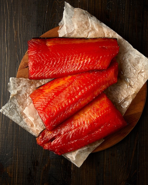 Smoked salmon fish over rustic background