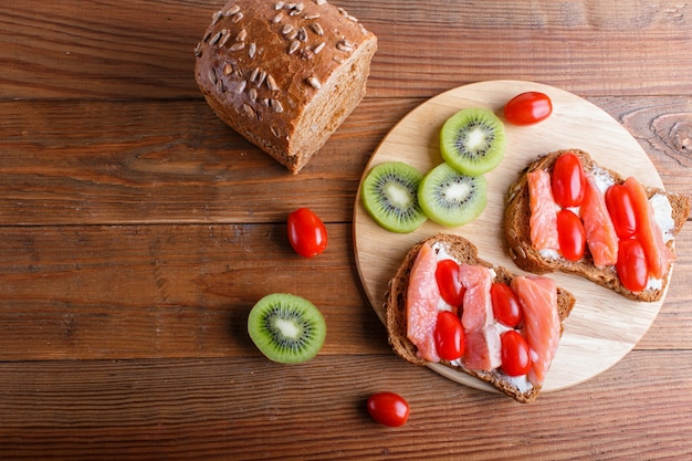 Smoked salmon sandwiches with butter on wood