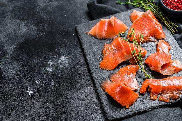 Smoked salmon slices with spices and herbs