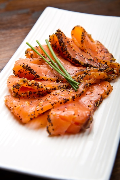 Smoked salmon on white dish with chive