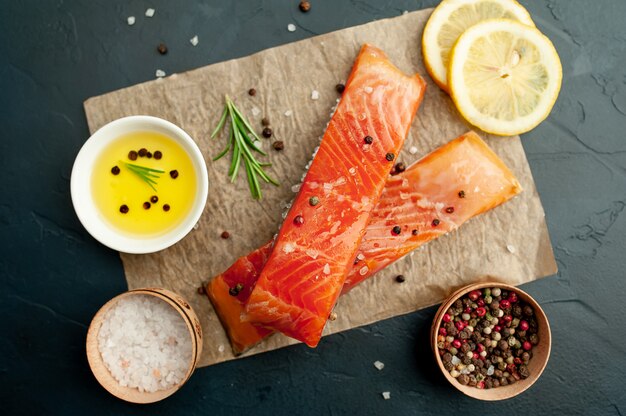 smoked salmon with spices on a stone background