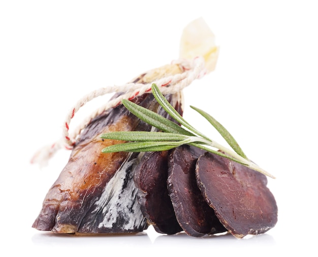 Smoked sausage cut on various pieces isolated on a white surface