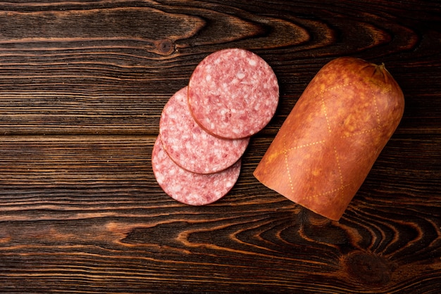 Smoked sausage on a dark wooden table