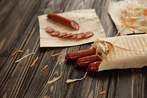 Smoked sausages wrapped in pita breadphoto with copy space